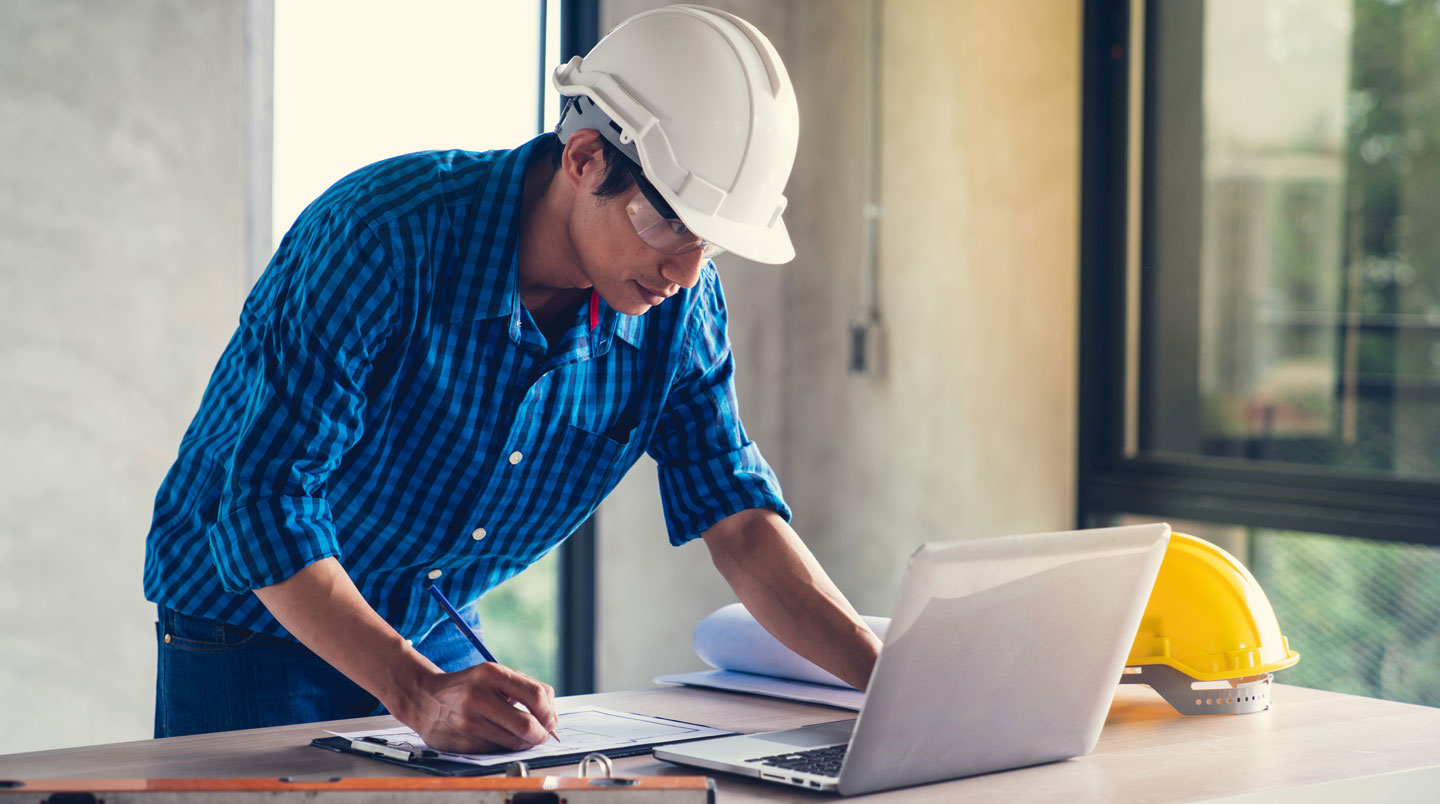 Renovation project timeline and budget documents on contractor desk showing detailed planning